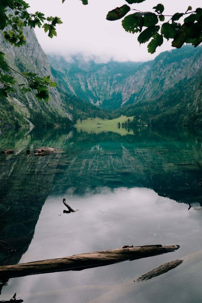 Reflet miroir parfait des montagnes et des sapins dans l'eau calme et transparente du lac Obersee en Bavière