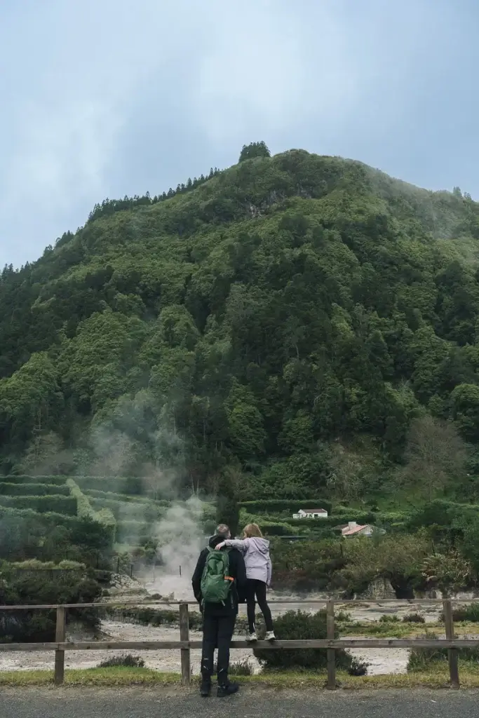 famille observant les fumerolles volcaniques de Furnas à São Miguel aux Açores