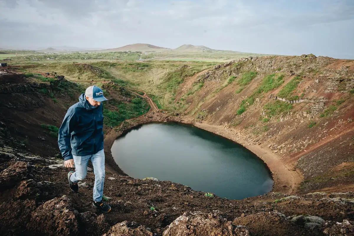 Randonnée sur la crête du cratère volcanique Kerið et son lac bleu en Islande en été